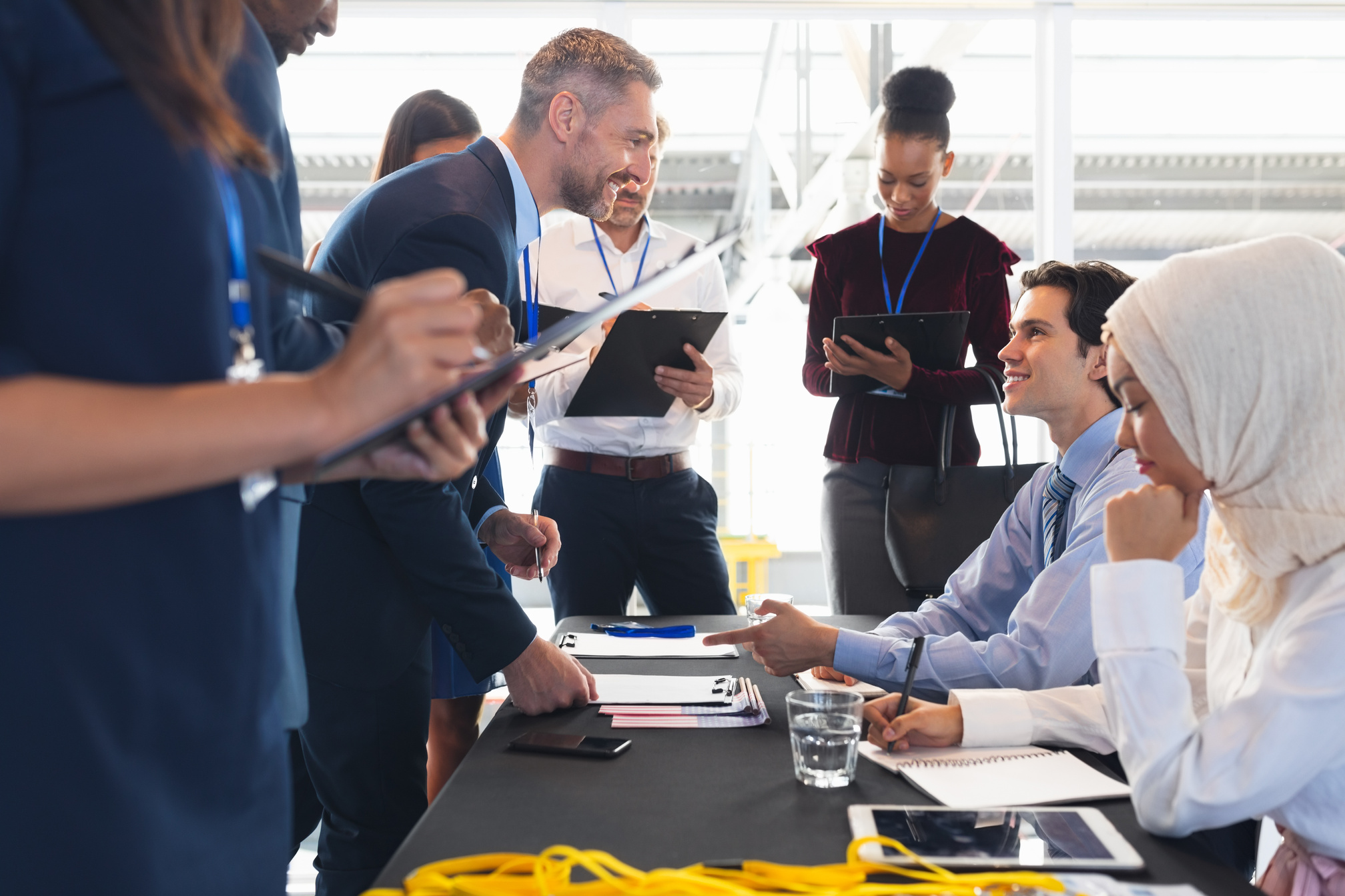 Business people checking in at conference registration table